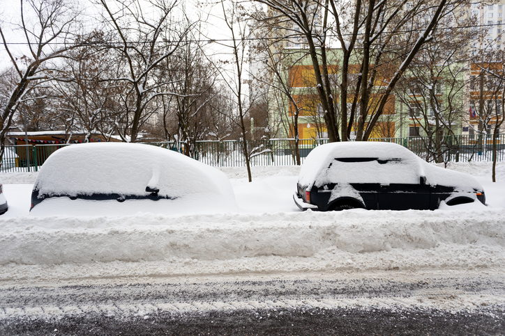 Heavy snowfall. The blizzard has covered the roads. Cars are stuck in snowdrifts.