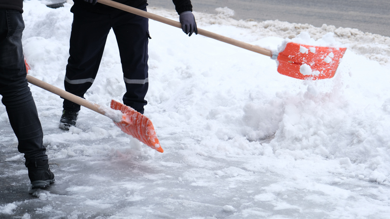 Municipal workers are cleaning the sidewalks blocked by snow.