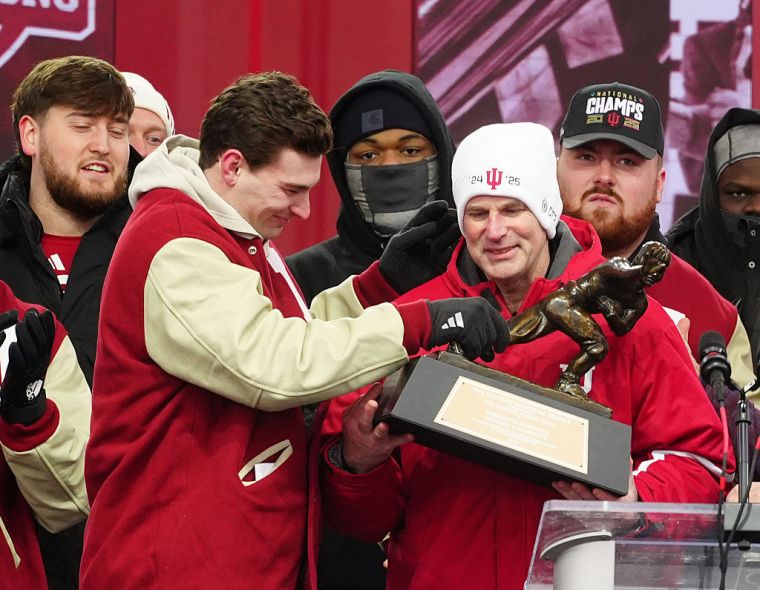 From left to right Indiana Hoosiers quarterback and 2025 Heisman Trophy winner Fernando Mendoza and coach Curt Cignetti hold the Heisman Trophy