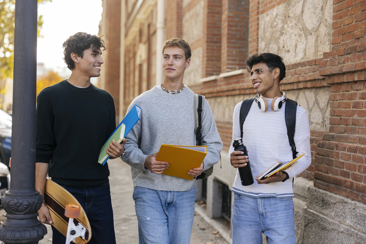 Three young men walking together on campus