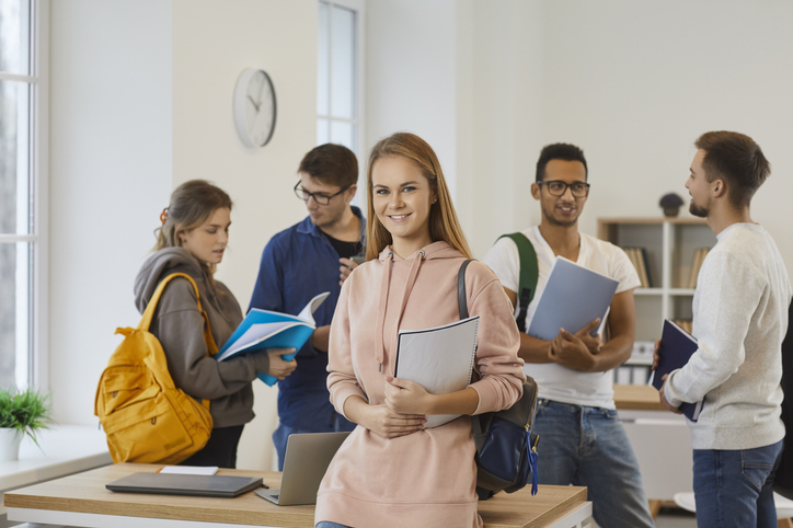Smiling teen girl student in university