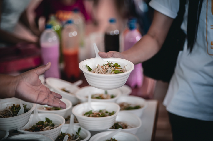 Volunteers are giving food to the homeless poor, Free distribution of food to the poor in today's society