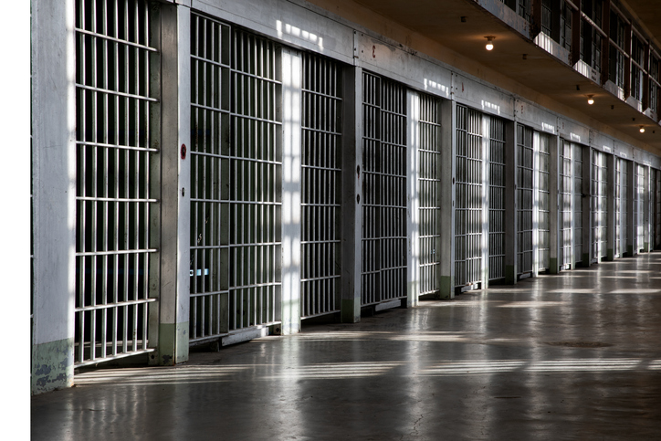 A long hallway with many bars on the windows