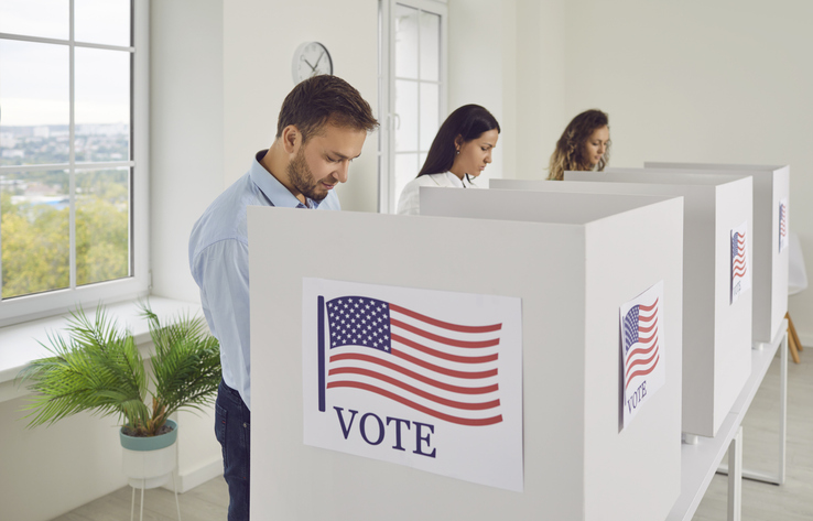 Different thoughtful people casting their votes inside voting booths during elections.