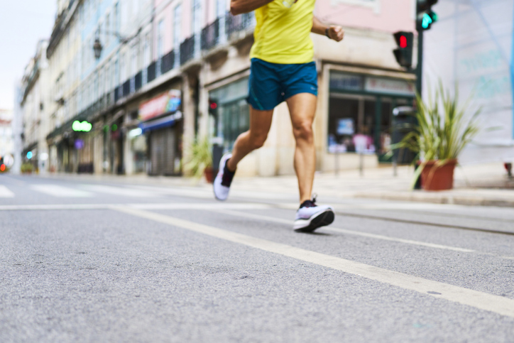 Adult person running on urban city street for fitness training