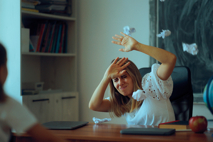 Naughty Students Trowing Paper Balls at Stressed Teacher
