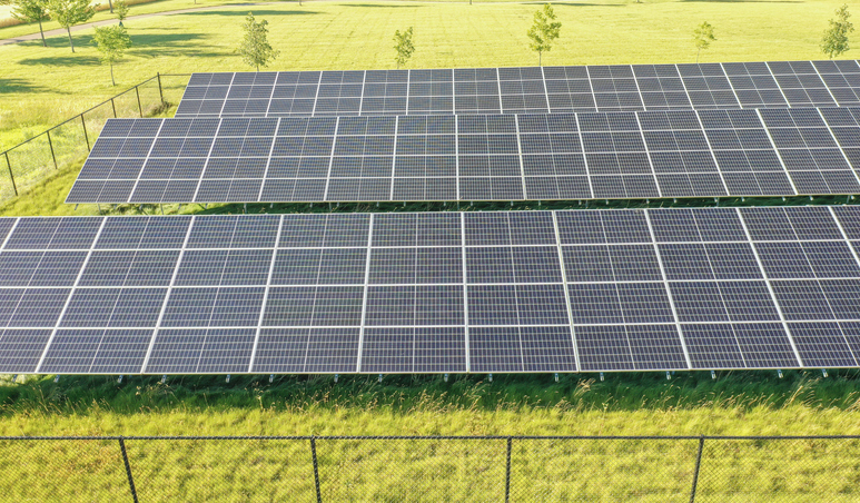 Aerial view of solar panels in a green field on a sunny day in Goshen, Indiana