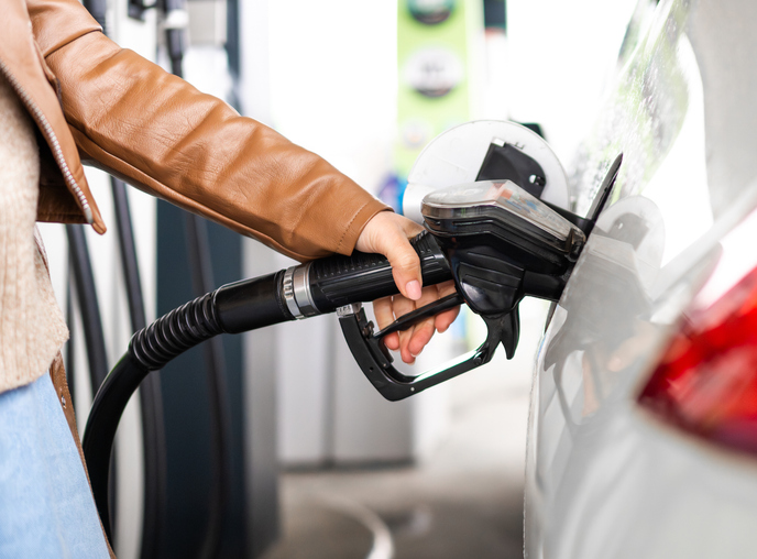 Woman Refueling A Car Holding A Fuel Nozzle