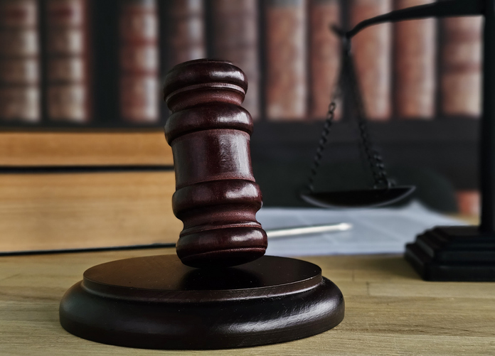 Justice is served with a gavel and scales of justice in a courtroom