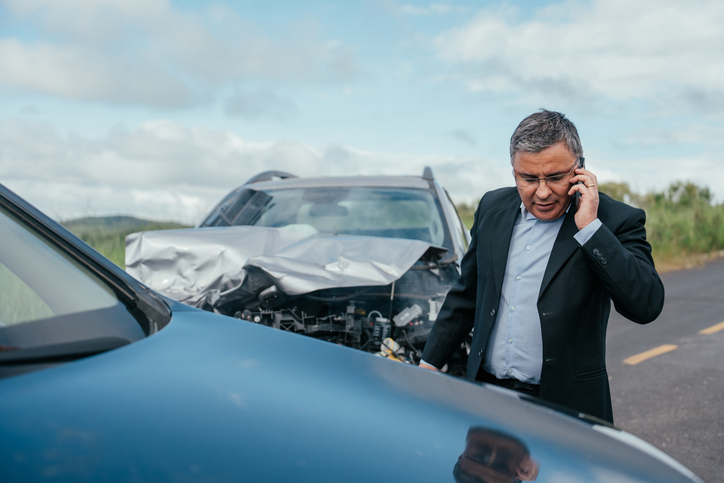 Man worried after hitting another car in traffic.