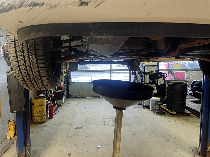 Car on lift at garage getting it's oil changed