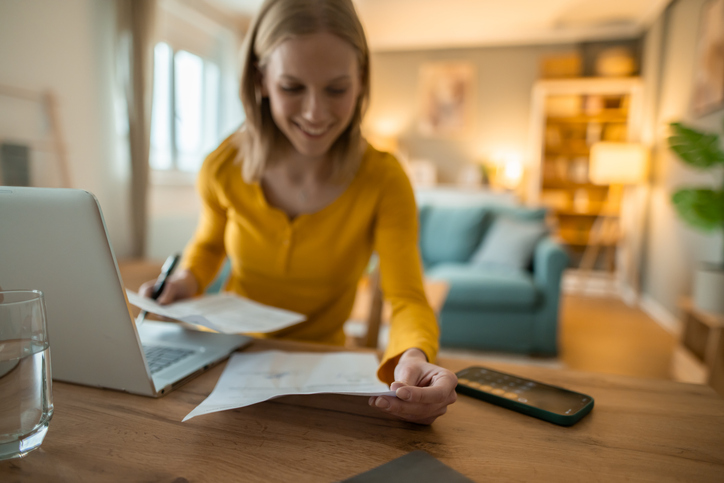 Woman working remotely from home doing online finances