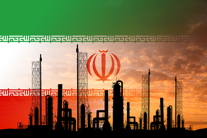 Oil refinery with Iranian flag in the background