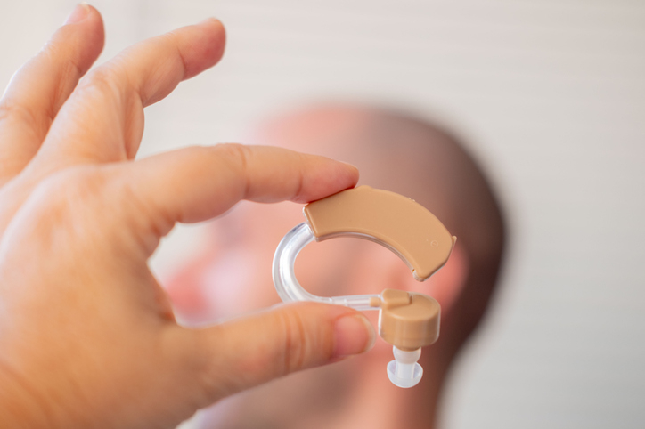 behind-the-ear hearing aid, closeup audiological hearing support, modern sound device, healthcare assistance, professional medical treatment, Technological progress ENT medicine, improve quality life