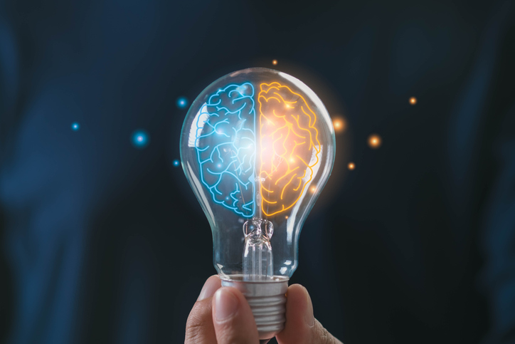 Creative brain concept with dual thinking in light bulb, left and right hemisphere symbolizing logic and creativity, innovation mindset, problem solving, emotional intelligence, smart decision making