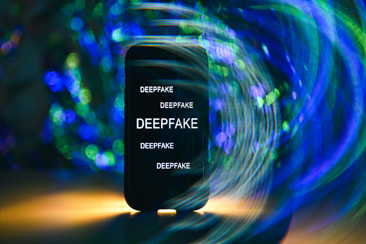 Smartphone screen displaying deepfake text against abstract background