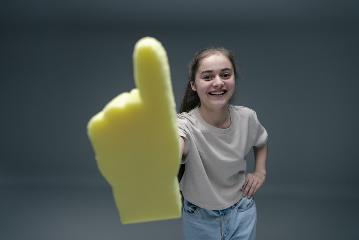 Girl cheering with foam hand