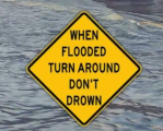 Current image: Yellow road sign that says "WHEN FLOODED TURN AROUND DON'T DROWN