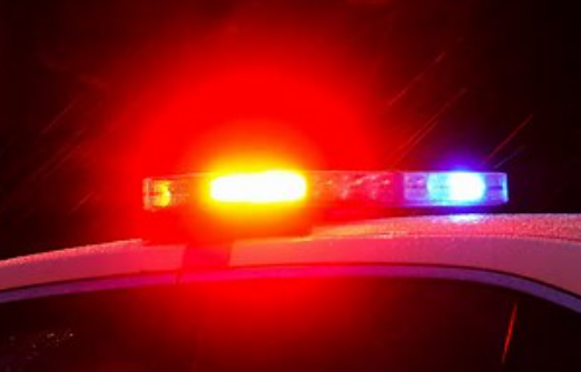 Red and blue emergency vehicle lights illuminating the night.