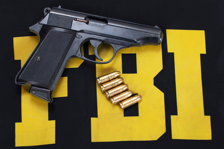 FBI concept with handgun and ammunition on black uniform