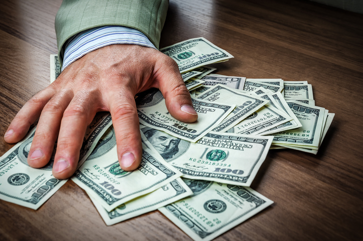 Businessman hand take, grab the money dollars from the table