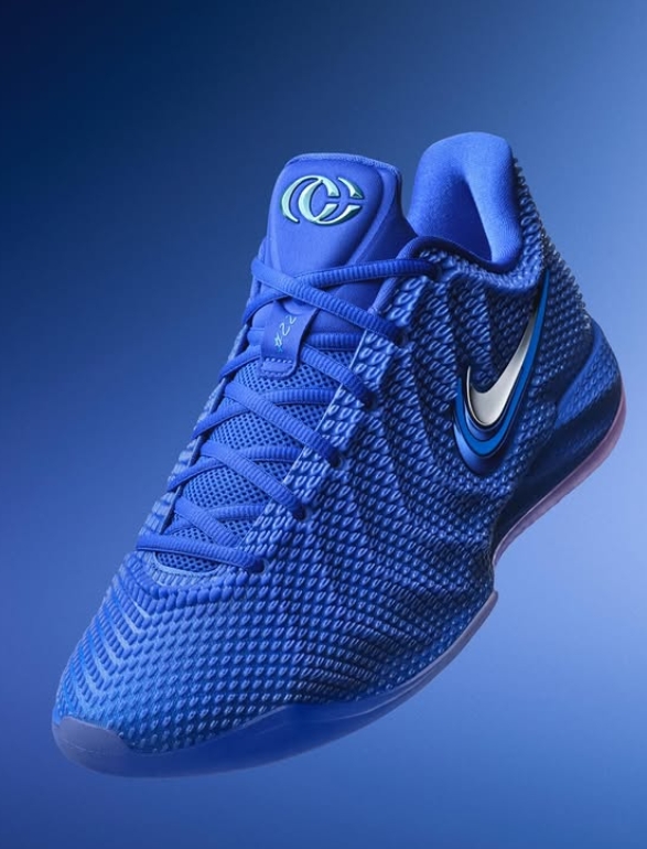 A blue Nike Kyrie 6 basketball shoe with a distinctive swirl pattern and Nike logo.