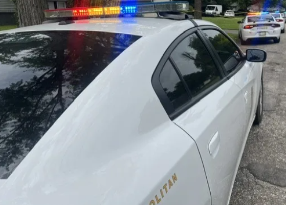Police vehicles with flashing lights on a residential street