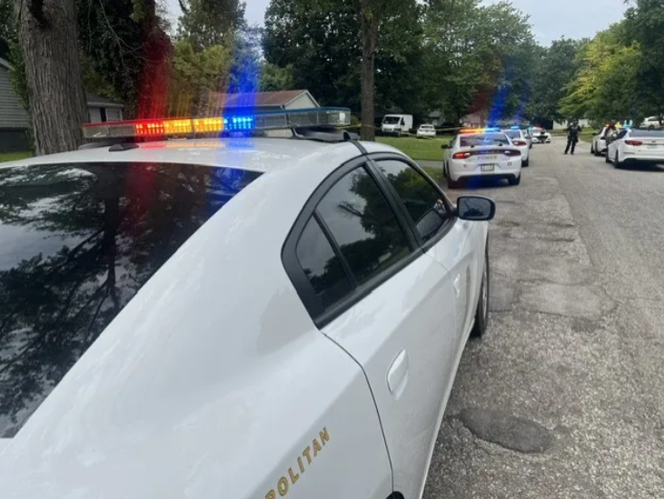 Police vehicles with flashing lights on a residential street