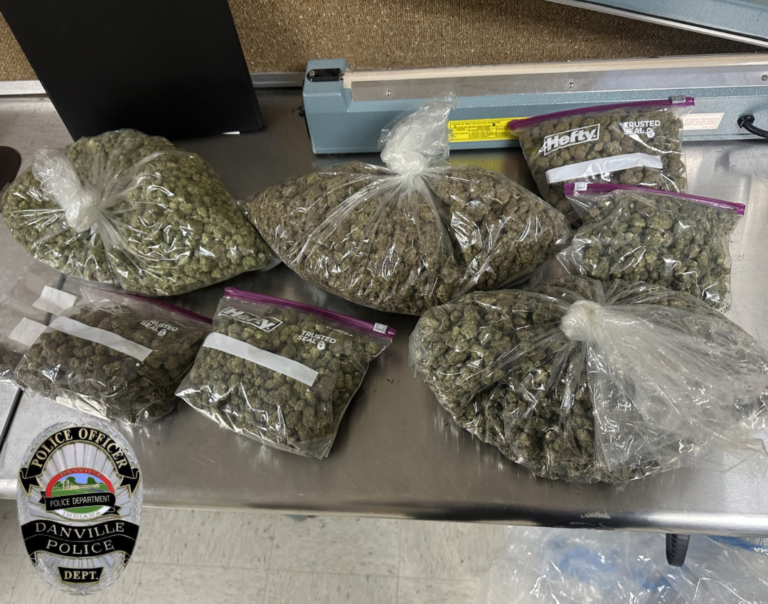 Several clear plastic bags containing what appears to be marijuana or a similar substance, with a Danville Police Department patch visible in the image.
