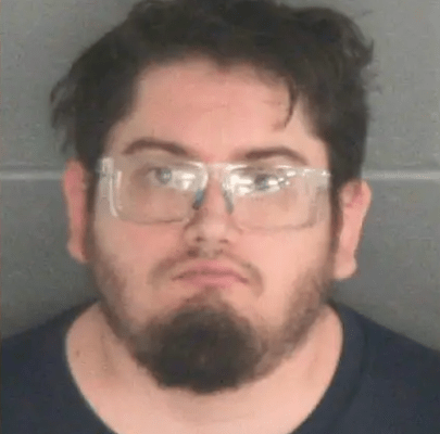 A man with a beard and glasses looking directly at the camera.