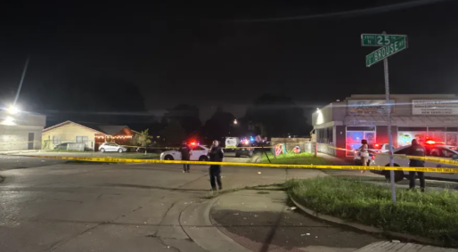 Nighttime scene with emergency vehicles, police tape, and a street sign for 17th and Walnut.