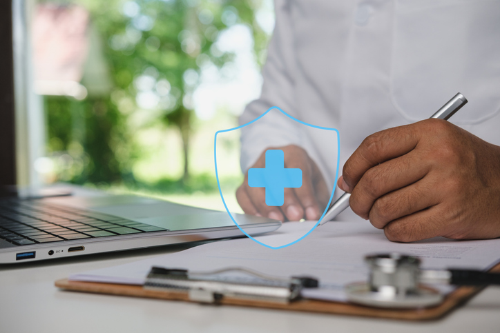 Doctor Reviewing and Signing Medical Insurance Documentation for Patient Coverage Verification, Healthcare Benefits Administration with Digital Health Protection Overlay in Modern Medical Workspace