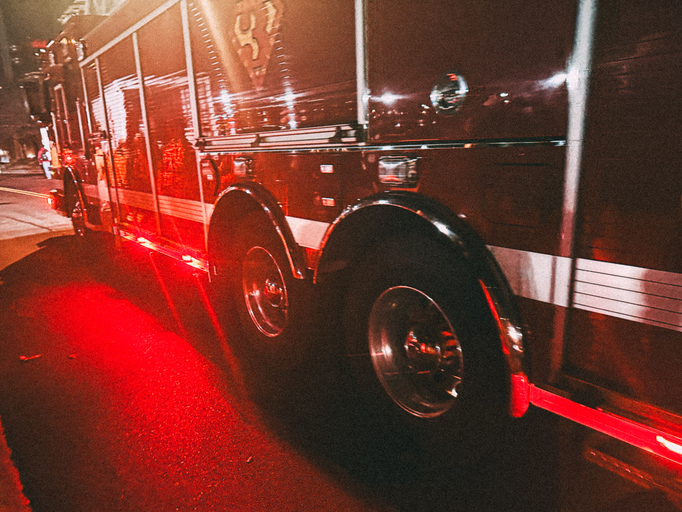 Large Tires on a Fire Truck with Flashing Red Lights in an Emergency First Response - Taken on a Mobile Device