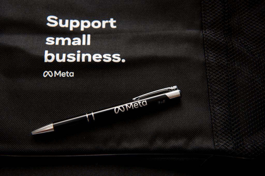 A black fabric bag with the text "Support small business." and the Meta logo.