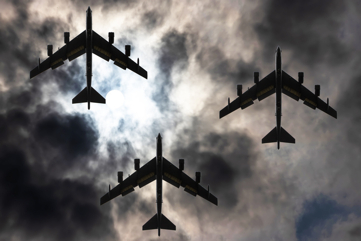 Three Boeing B-52 Stratofortress military bomber aircrafts in the dramatic sky