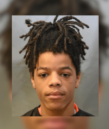 A young person with dreadlocks looking directly at the camera.