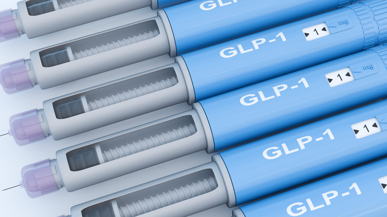 A 3D render of blue injectable medication pens. Each pen clearly displays the text "GLP-1".