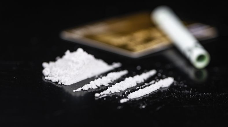 Dark plate with a portion of Cocaine as close-up shot
