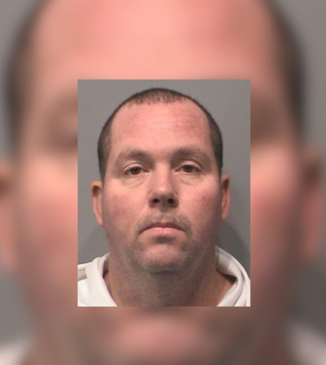 Mugshot of a middle-aged man with a serious expression.