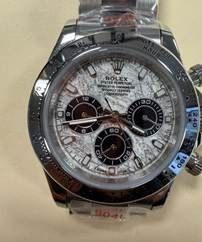 A close-up view of a silver Rolex Daytona chronograph wristwatch with a white dial and subdials.