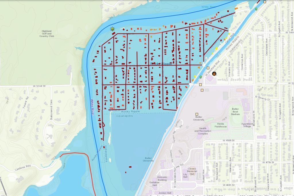 Map showing a grid of city blocks and streets near a large body of water, with numerous red dots indicating locations.