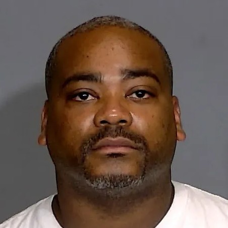 Headshot of a middle-aged African American man with a beard, looking directly at the camera with a neutral expression.