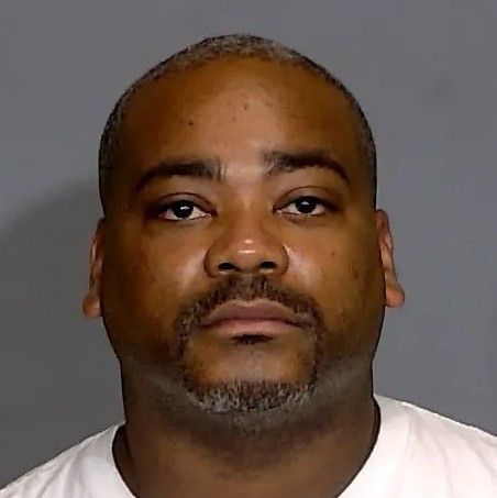 Headshot of a middle-aged African American man with a beard, looking directly at the camera with a neutral expression.