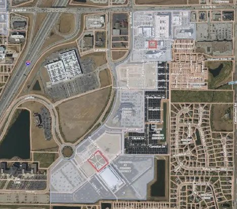 Aerial view of a large commercial and industrial area with numerous buildings, roads, and parking lots.