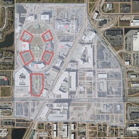 Aerial view of a large university campus with multiple buildings, roads, and parking lots.