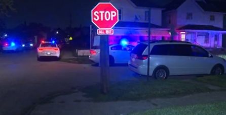 Emergency vehicles with flashing lights on a residential street at night