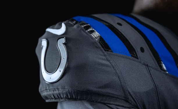 A close-up view of a black and blue sports helmet with a horseshoe logo, likely representing the Indianapolis Colts NFL team.